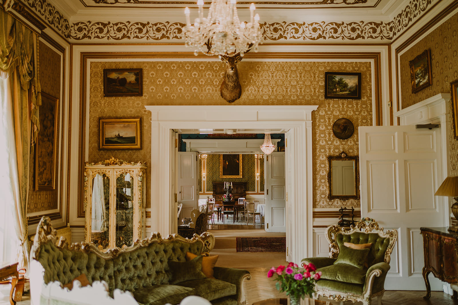 Ornate drawing room inside Drumtochty Castle with antique furniture and a chandelier