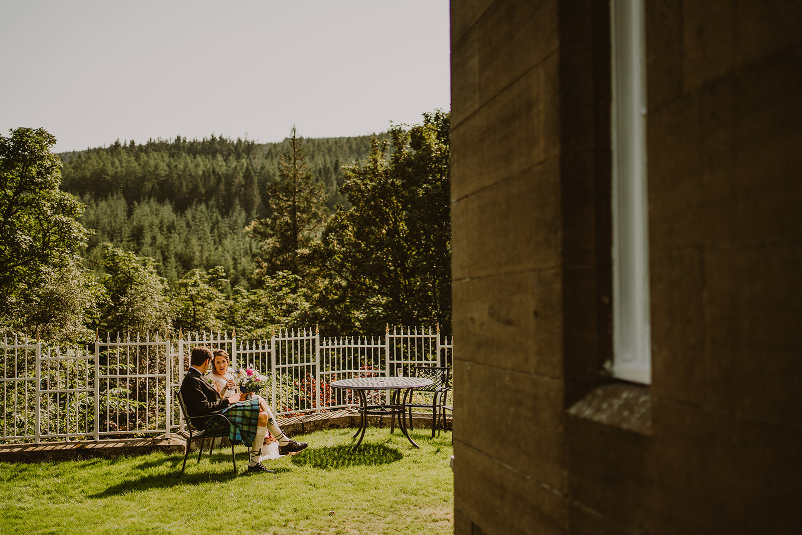 Newlyweds sitting together in the garden at Drumtochty Castle