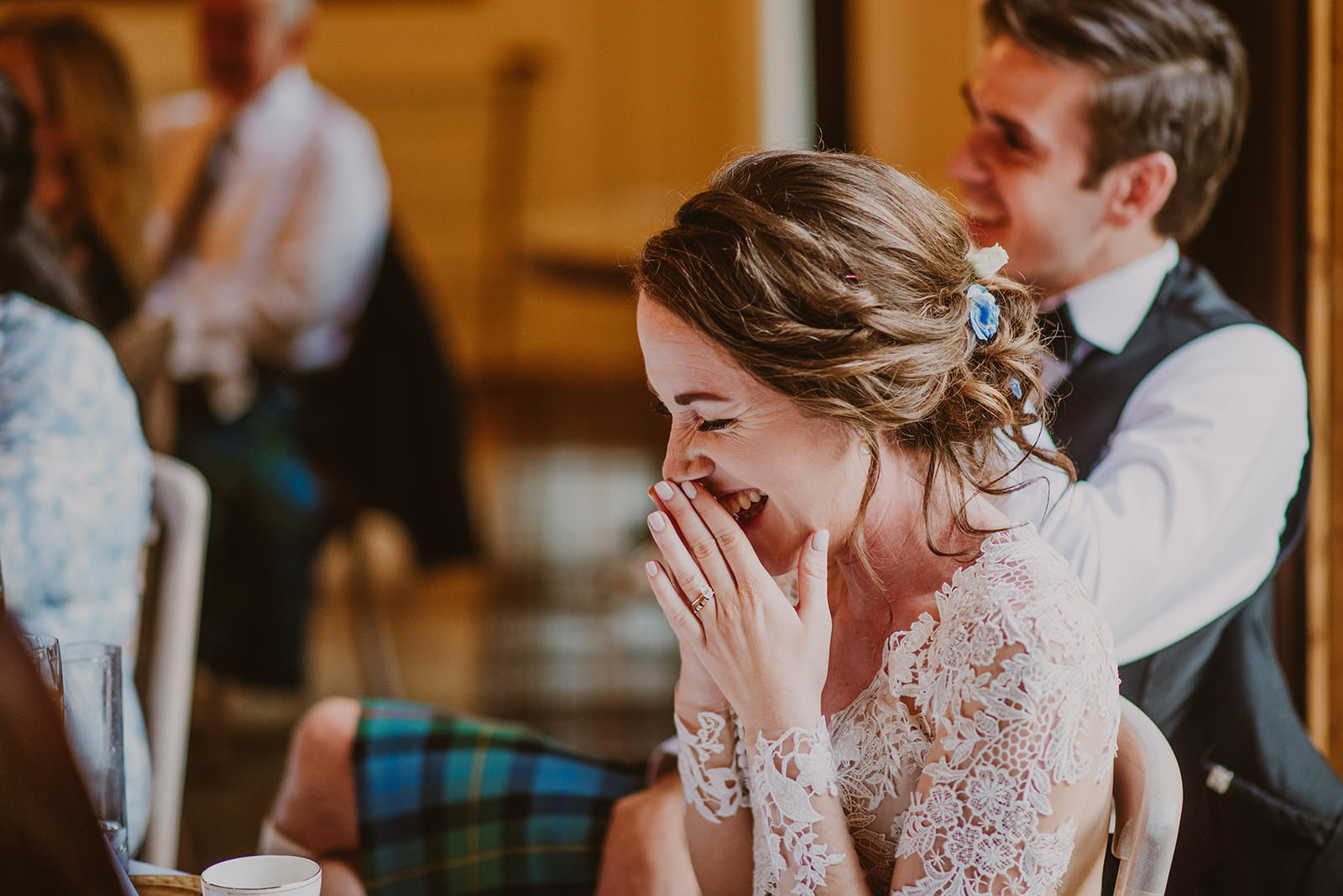 Bride laughing during a speech at the Drumtochty Castle wedding breakfast